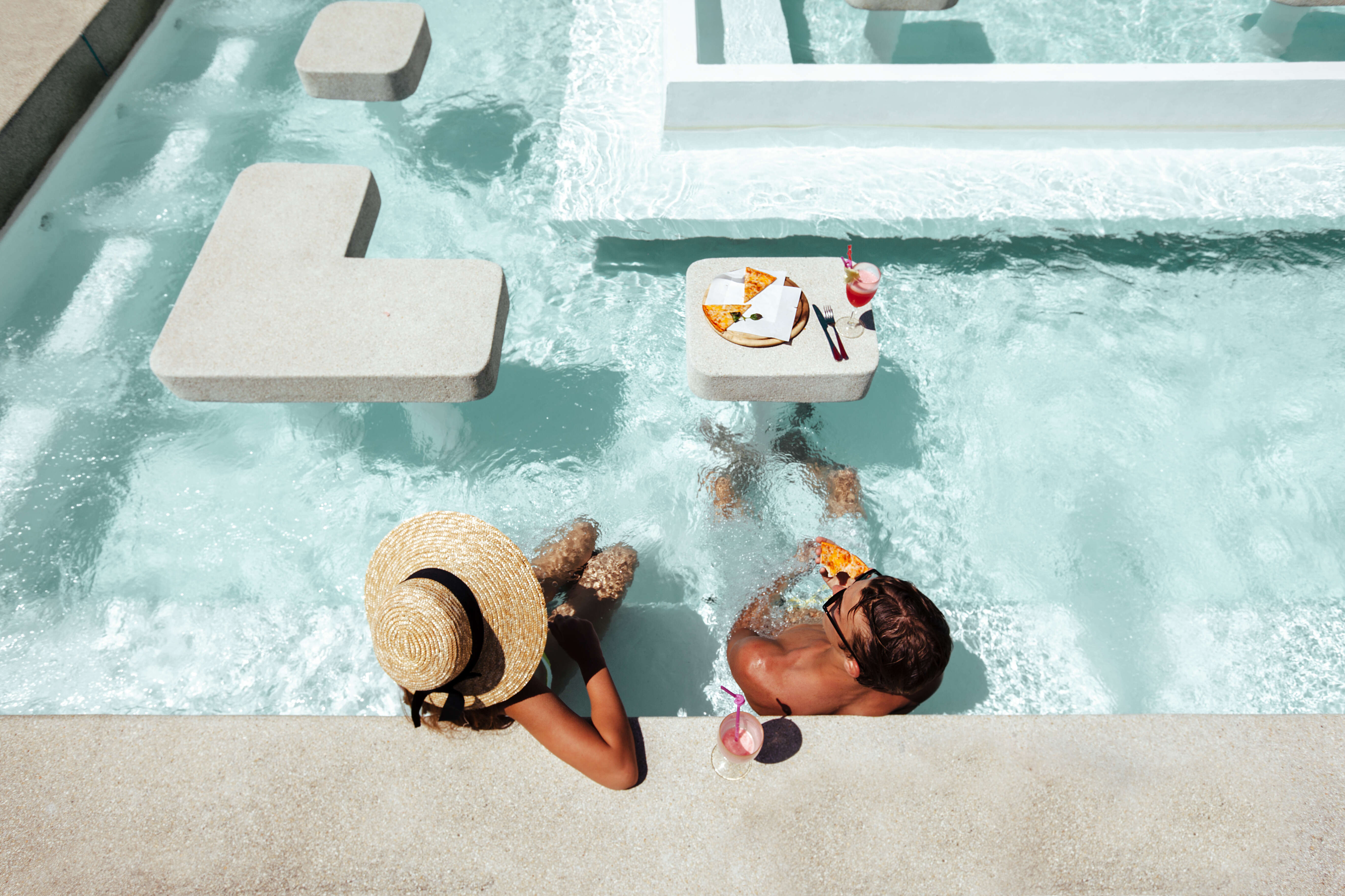 A couple at a luxury resort
      enjoying poolside service